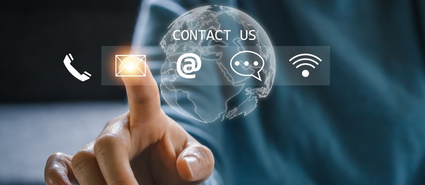 Contact us photo illustration concept with a hand of call center touching on a holographic screen with contact options.